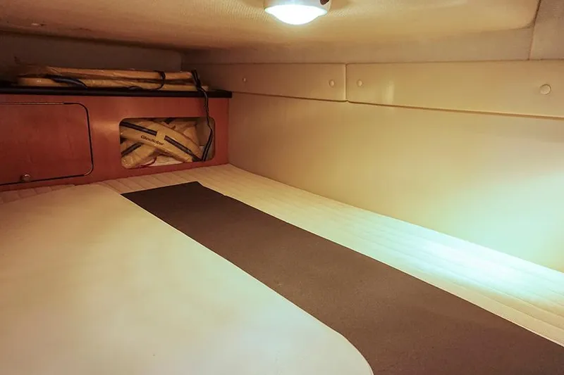 Slide: The Image of Interior cabin of 2000 Regal Commodore 2660 boat, featuring cozy sleeping area. - 32