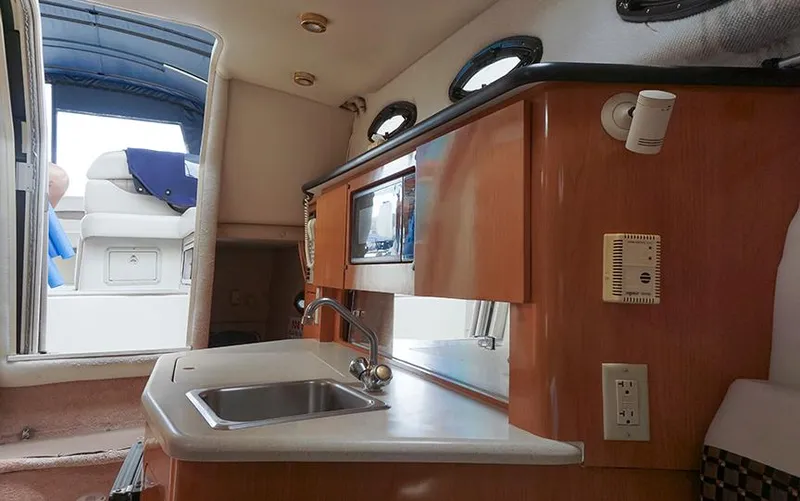 Slide: The Image of Interior of 2000 Regal Commodore 2660 boat with kitchenette and seating area. - 33