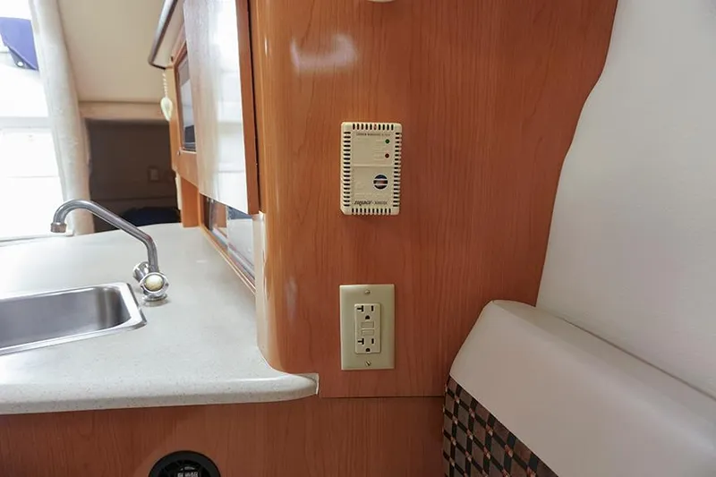 Slide: The Image of Interior of 2000 Regal Commodore 2660 boat with sink and wooden cabinetry. - 34