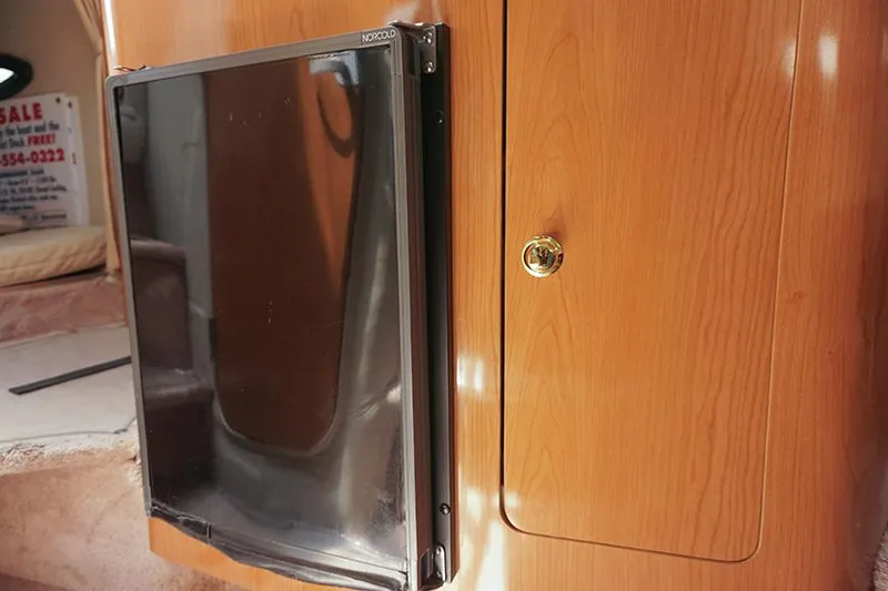 Slide: The Image of Wooden interior of 2000 Regal Commodore 2660 boat with cabinet and fridge. - 38