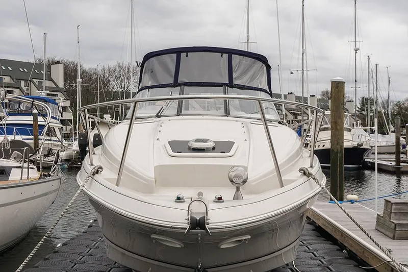 Slide: The Image of 2000 Regal Commodore 2660 boat docked at marina, front view, overcast sky. - 4