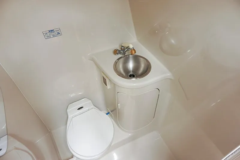 Slide: The Image of Compact bathroom in 2000 Regal Commodore 2660 boat with toilet and sink. - 40