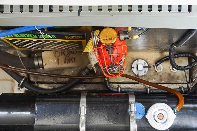 Slide: The Image of Engine compartment of a 2000 Regal Commodore 2660 boat, showing various mechanical components. - 44