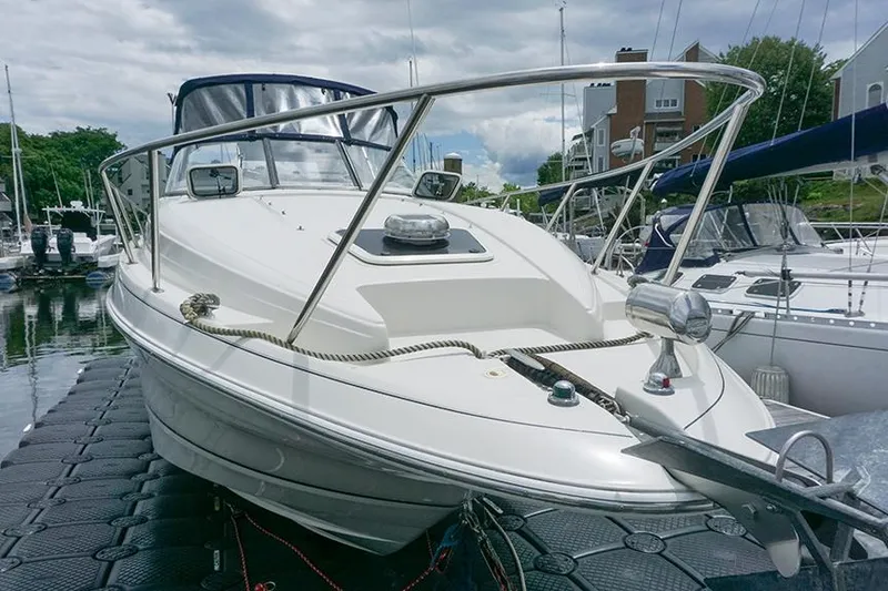 Slide: The Image of 2000 Regal Commodore 2660 boat docked at marina, featuring sleek design and stainless steel railings. - 6