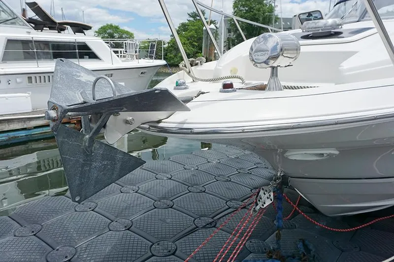 Slide: The Image of 2000 Regal Commodore 2660 boat anchored at a marina, featuring a prominent anchor. - 7