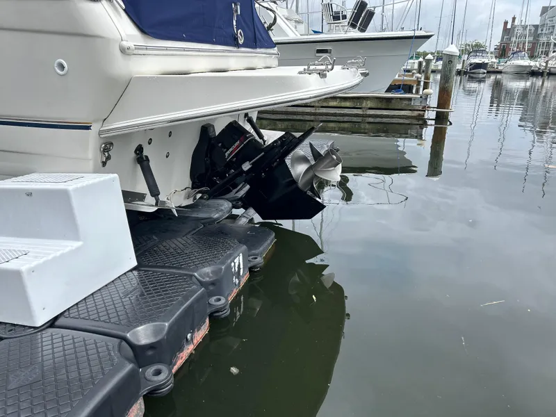 Slide: The Image of 2000 Regal Commodore 2660 boat docked, showing stern and propeller in marina. - 8