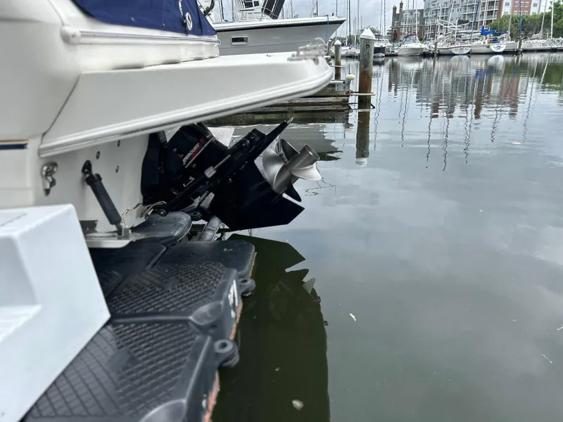 Slide: The Image of Rear view of a 2000 Regal Commodore 2660 boat docked in a marina. - 9