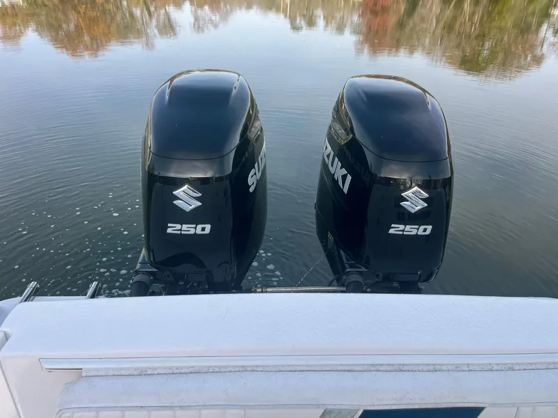 Slide: The Image of Twin Suzuki 250 outboard motors on a 2003 Pro-Line 30 WALKAROUND boat. - 10