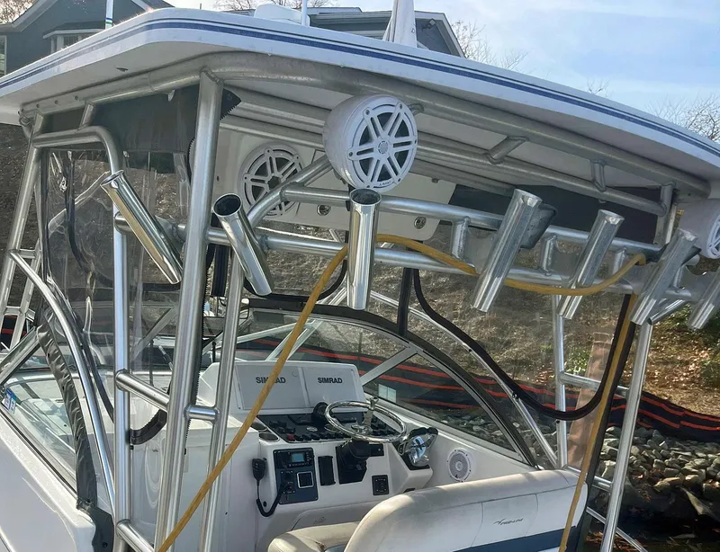 Slide: The Image of 2003 Pro-Line 30 Walkaround boat interior with rod holders and control panel. - 13