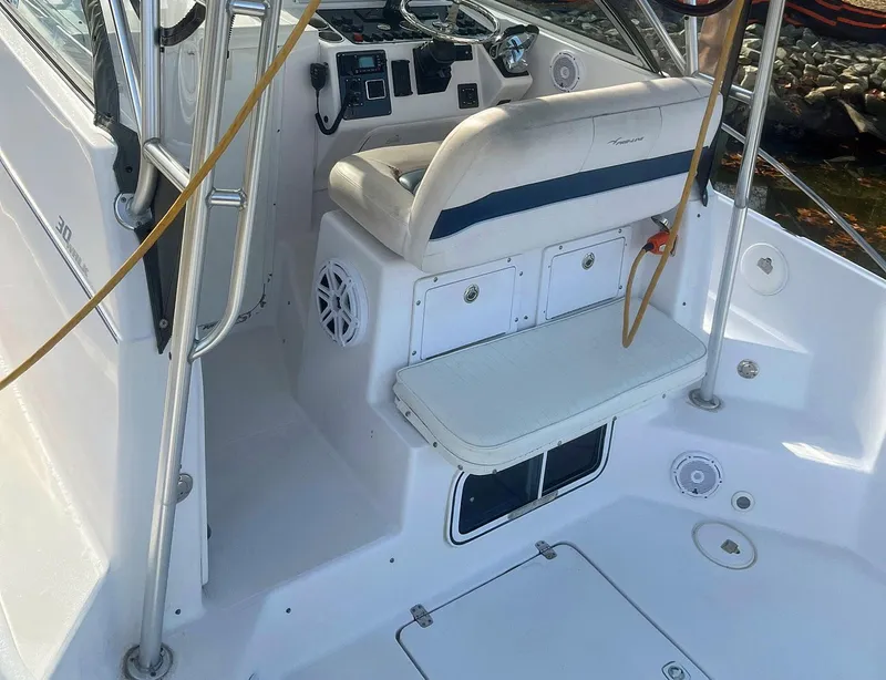 Slide: The Image of 2003 Pro-Line 30 Walkaround boat interior with seating and control panel. - 14