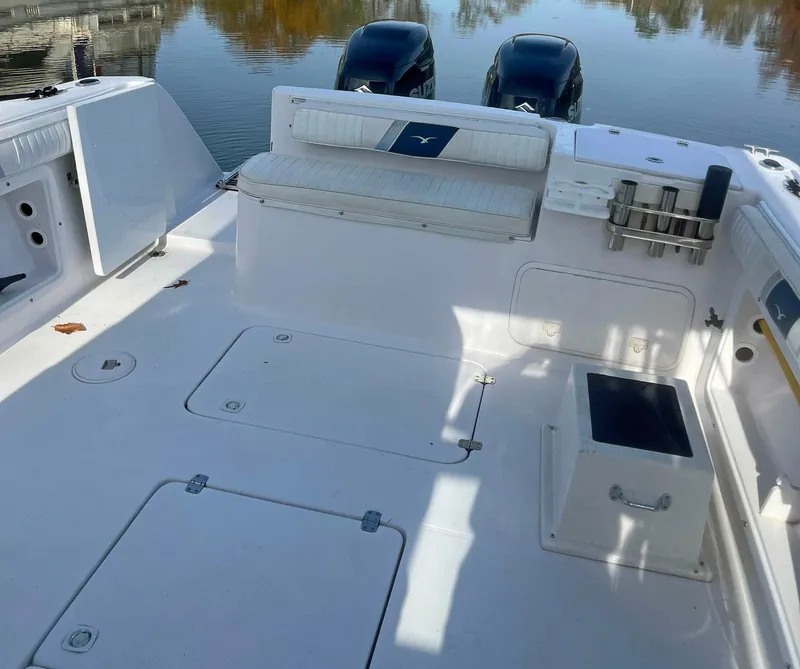 Slide: The Image of 2003 Pro-Line 30 Walkaround boat deck with seating and dual engines. - 4
