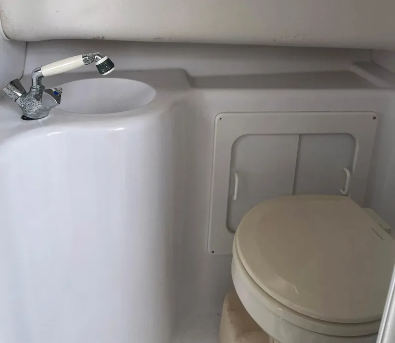 Slide: The Image of 2003 Pro-Line 30 WALKAROUND boat bathroom with sink and toilet. - 6