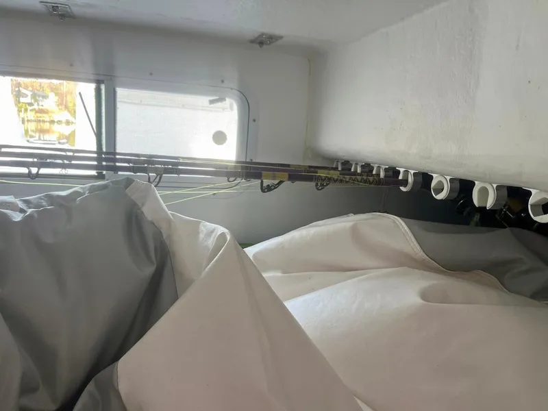 Slide: The Image of Interior of 2003 Pro-Line 30 WALKAROUND with fishing rods and storage area. - 7