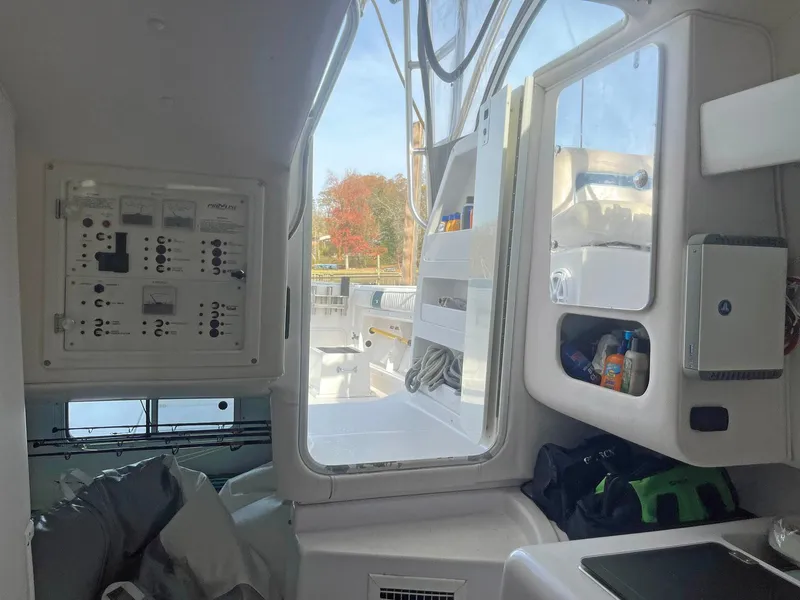 Slide: The Image of Interior view of 2003 Pro-Line 30 WALKAROUND boat, showing control panel and storage. - 8