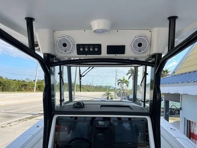 Slide: The Image of 2025 World Cat 295 CC boat dashboard with speakers and control panel. - 3