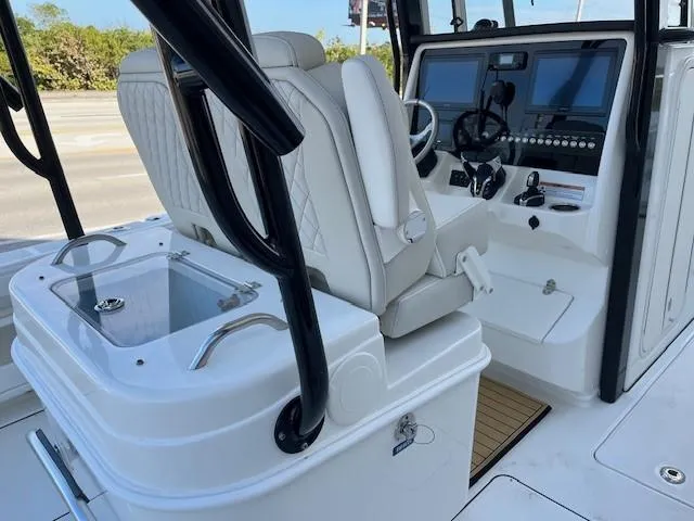 Slide: The Image of 2025 World Cat 295 CC boat interior with modern helm and seating. - 7