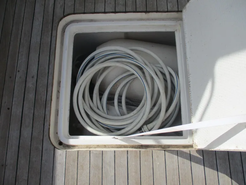 Slide: The Image of Storage compartment with coiled hose on 1997 Ocean Yachts 40 Super Sport. - 11