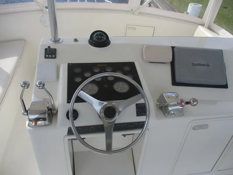 Slide: The Image of 1997 Ocean Yachts 40 Super Sport helm with steering wheel and Garmin navigation system. - 14