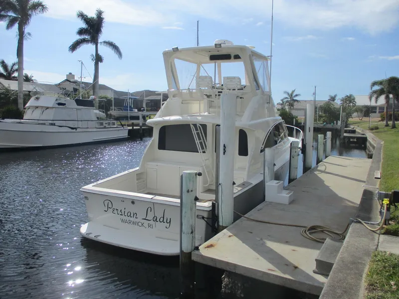 Slide: The Image of 1997 Ocean Yachts 40 Super Sport docked in a sunny marina. - 2