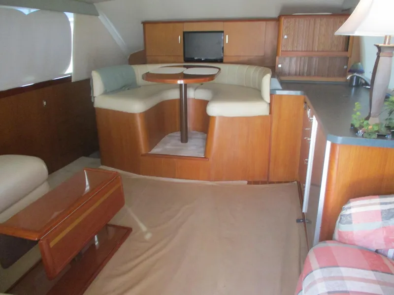 Slide: The Image of Interior of 1997 Ocean Yachts 40 Super Sport with seating, table, and cabinetry. - 25
