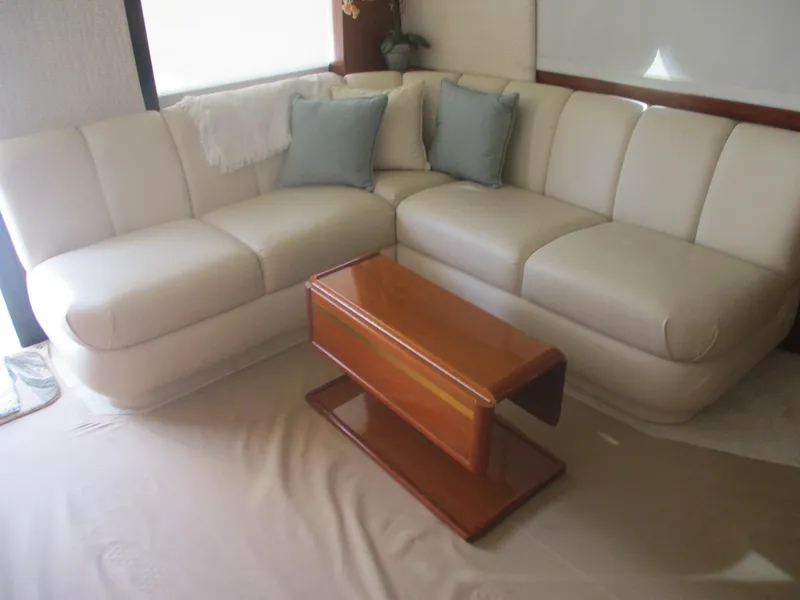 Slide: The Image of Luxurious interior of 1997 Ocean Yachts 40 Super Sport with cream sofa and wooden table. - 26