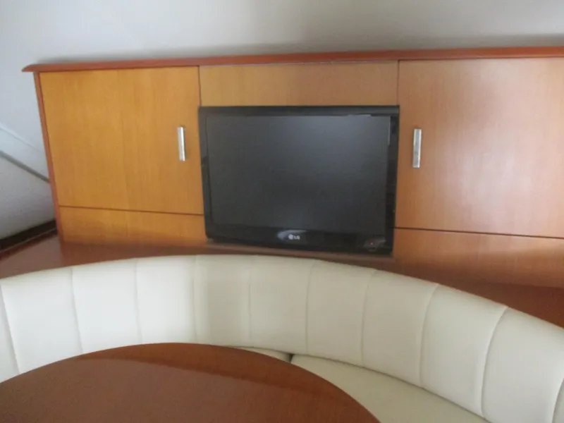 Slide: The Image of 1997 Ocean Yachts 40 Super Sport interior with TV and curved seating. - 27