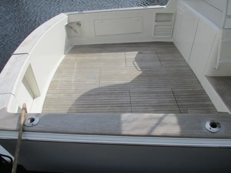 Slide: The Image of 1997 Ocean Yachts 40 Super Sport boat deck with wooden flooring and storage compartments. - 3