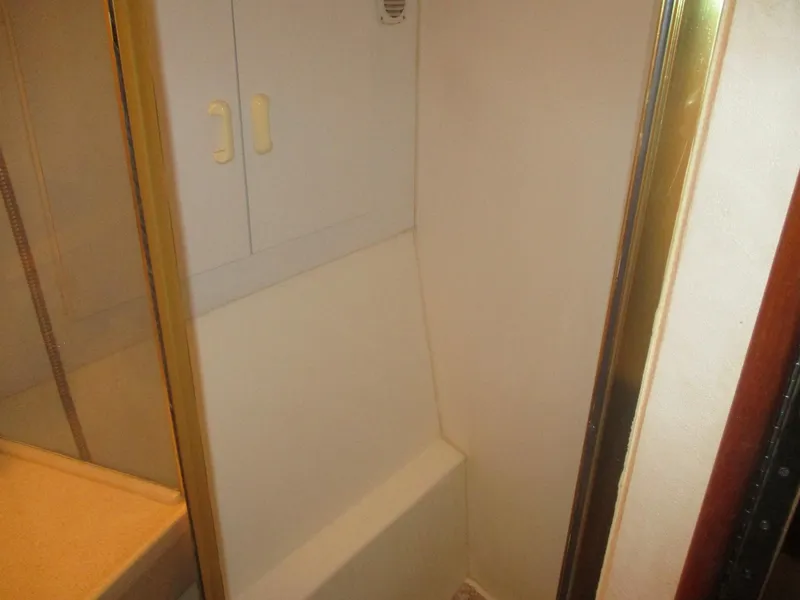 Slide: The Image of Shower area in 1997 Ocean Yachts 40 Super Sport, featuring compact design and storage. - 39