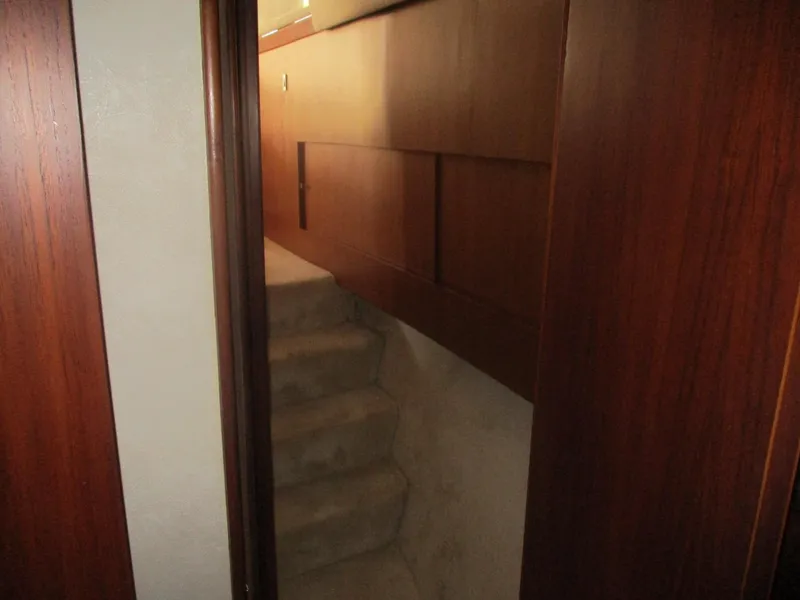 Slide: The Image of Interior stairs of 1997 Ocean Yachts 40 Super Sport with wooden paneling. - 46