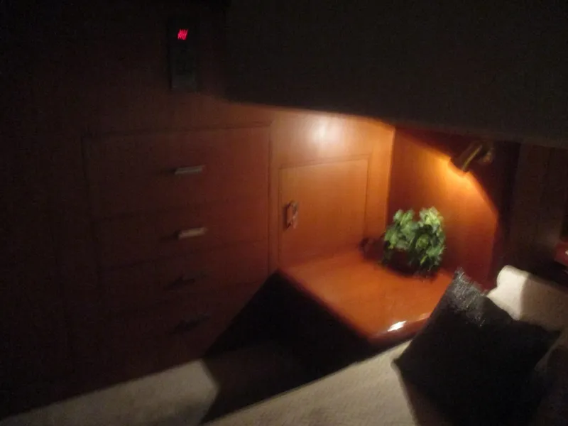 Slide: The Image of Cozy cabin interior of 1997 Ocean Yachts 40 Super Sport with wooden cabinetry and soft lighting. - 47