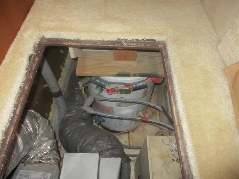 Slide: The Image of Engine room of 1997 Ocean Yachts 40 Super Sport, showing equipment and piping. - 49