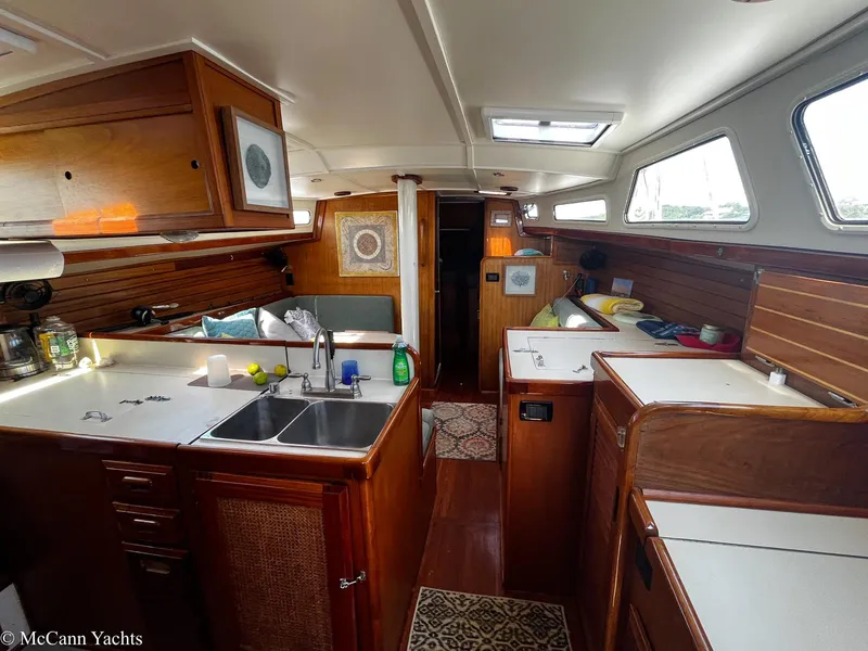 Slide: The Image of Interior of a 1973 Challenger 40 yacht with wooden cabinetry and modern amenities. - 10