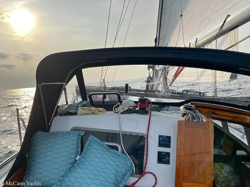 Slide: The Image of 1973 Challenger 40 sailboat at sea during sunset, featuring cockpit and sails. - 11