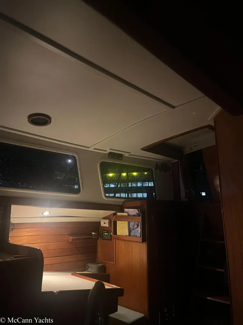 Slide: The Image of Interior of a 1973 Challenger 40 yacht, featuring wooden furnishings and ambient lighting. - 14