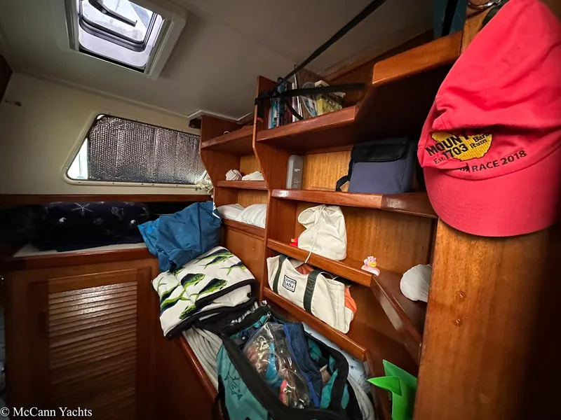Slide: The Image of Cozy cabin interior of a 1973 Challenger 40 yacht with wooden shelves and personal items. - 18
