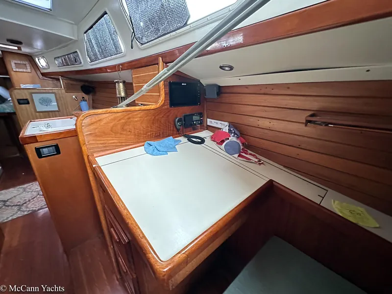 Slide: The Image of Interior of a 1973 Challenger 40 yacht with wooden paneling and navigation station. - 20