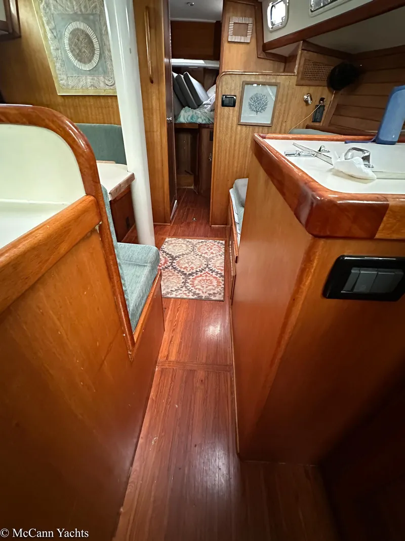 Slide: The Image of Interior of a 1973 Challenger 40 yacht with wooden finishes and cozy seating. - 22