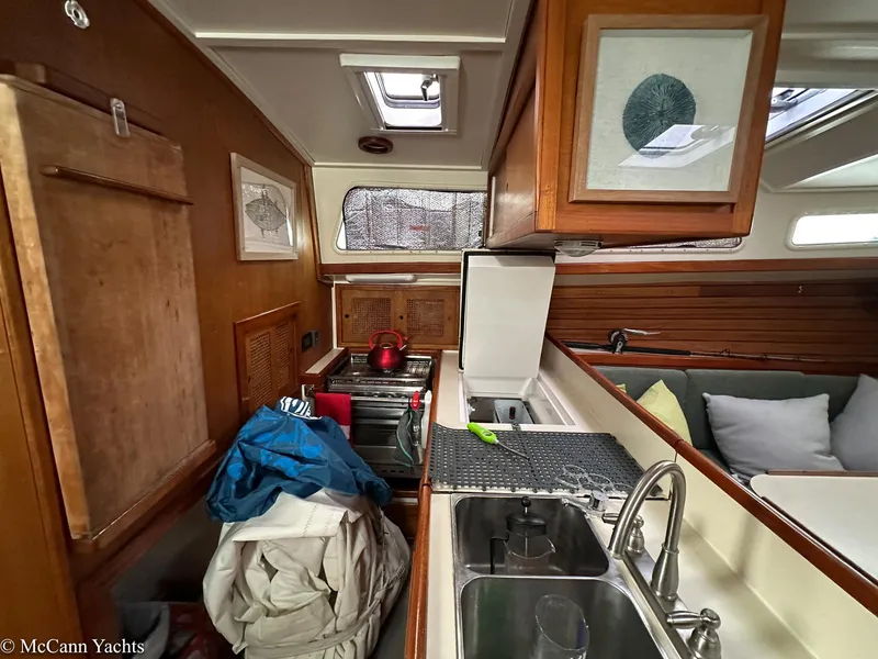 Slide: The Image of Interior of a 1973 Challenger 40 yacht with kitchen and seating area. - 23
