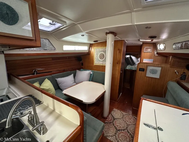 Slide: The Image of Interior of a 1973 Challenger 40 yacht with cozy seating and wooden accents. - 24