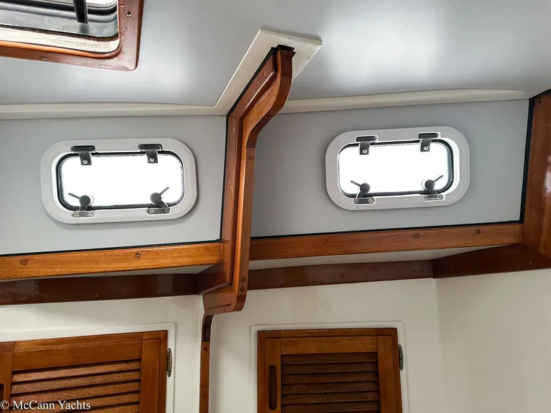 Slide: The Image of Interior of 1973 Challenger 40 yacht with wooden accents and portholes. - 28