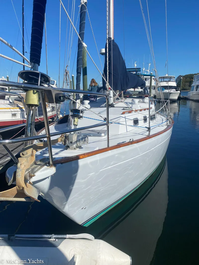 Slide: The Image of 1973 Challenger 40 sailboat docked in marina, clear blue sky background. - 3