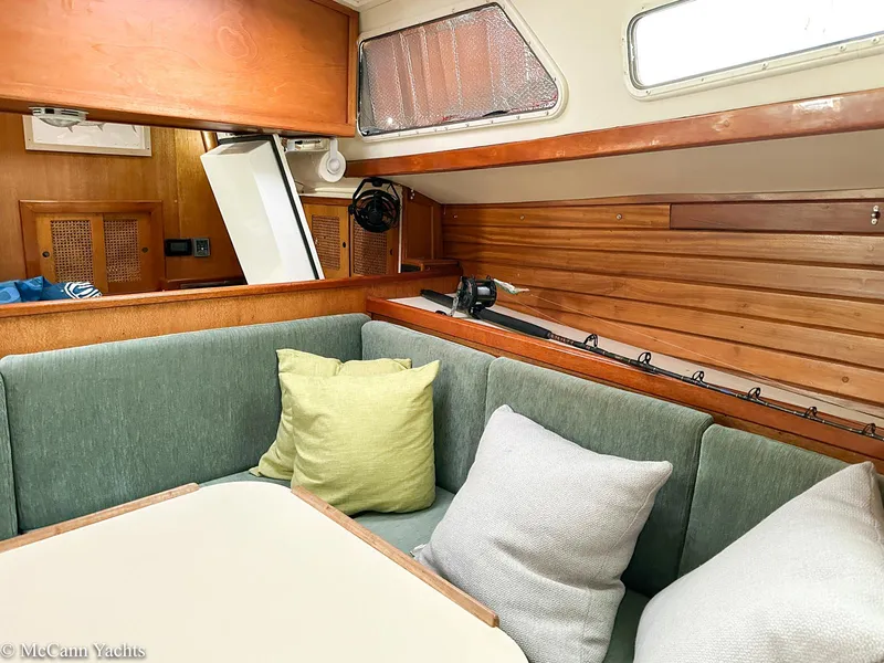 Slide: The Image of 1973 Challenger 40 yacht interior with wooden paneling and cushioned seating area. - 30