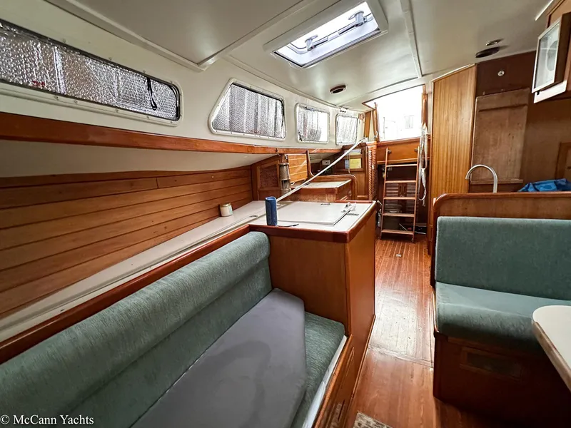 Slide: The Image of Interior of a 1973 Challenger 40 yacht with wood paneling and seating area. - 31
