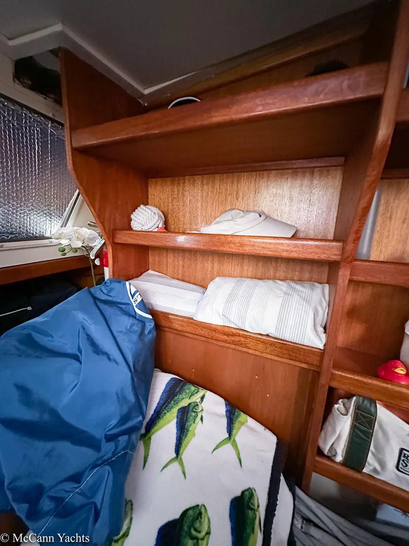 Slide: The Image of 1973 Challenger 40 yacht interior with wooden shelves and nautical-themed decor. - 34