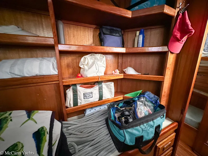 Slide: The Image of Wooden shelves with bags and accessories inside a 1973 Challenger 40 yacht cabin. - 36