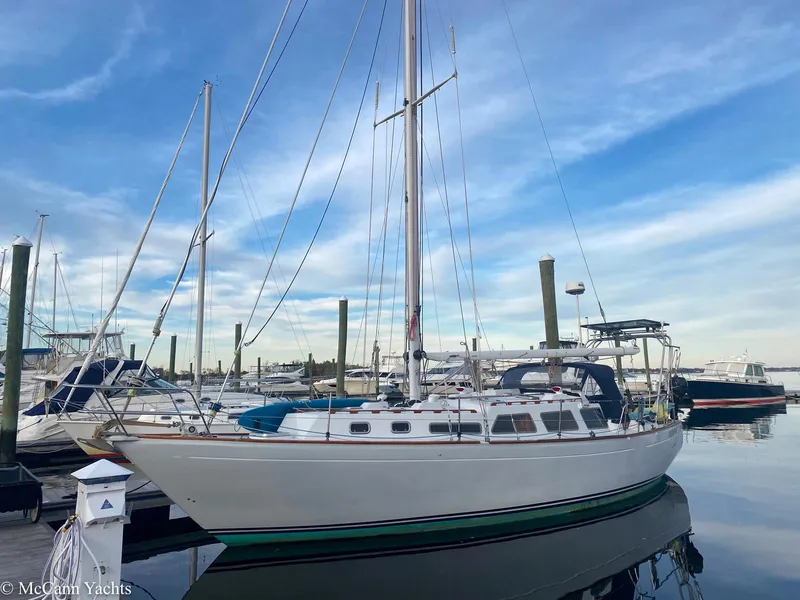 Slide: The Image of 1973 Challenger 40 sailboat docked at marina under blue sky. - 4