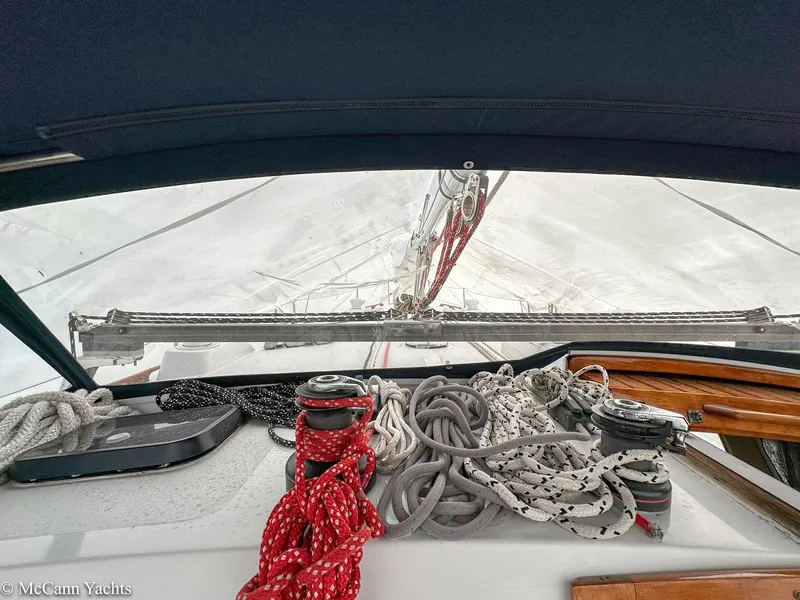 Slide: The Image of 1973 Challenger 40 sailboat cockpit with ropes and winches, view of mast and sails. - 45