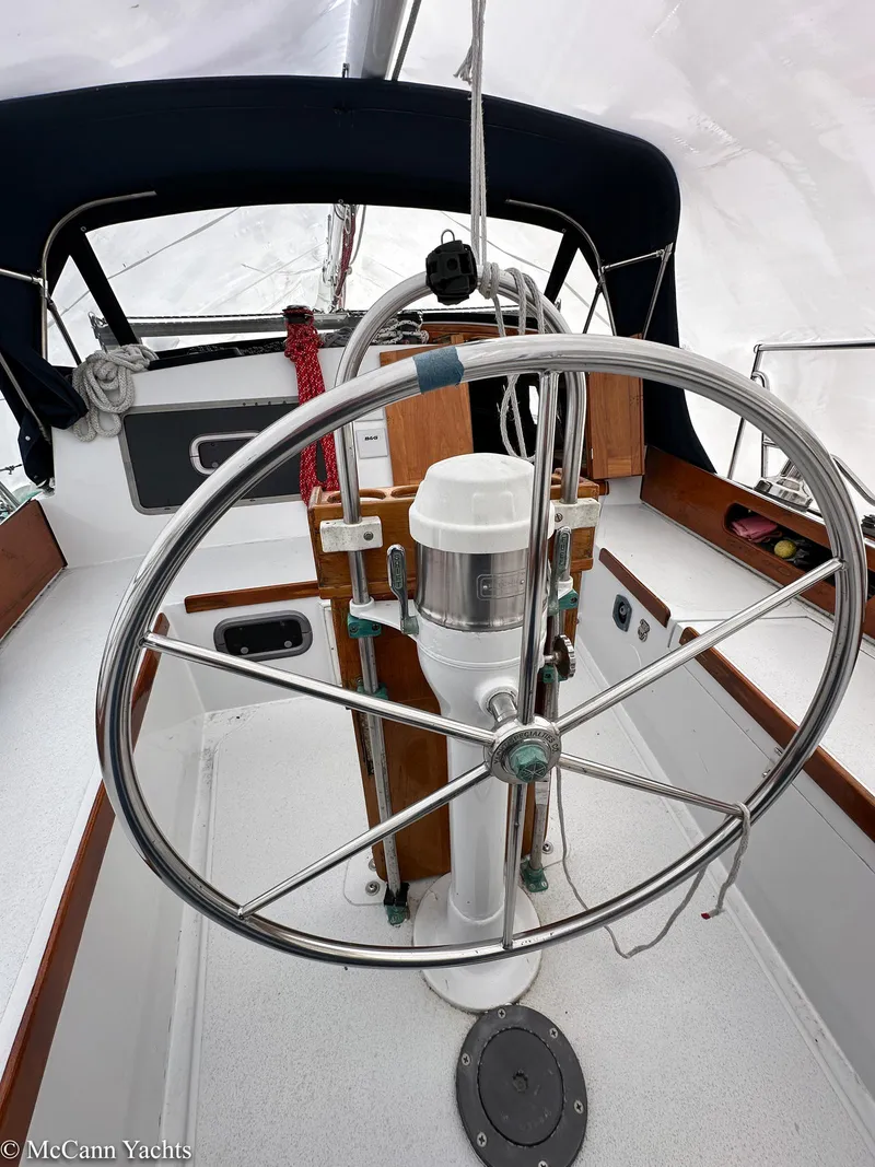 Slide: The Image of 1973 Challenger 40 sailboat cockpit with steering wheel and navigation equipment. - 46