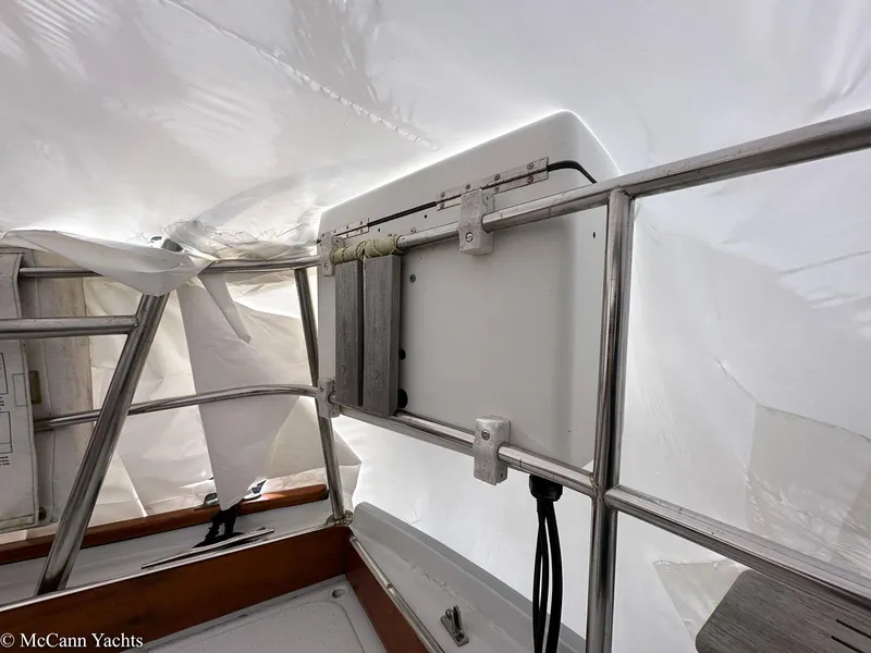 Slide: The Image of 1973 Challenger 40 yacht interior with metal framework and white covering. - 49