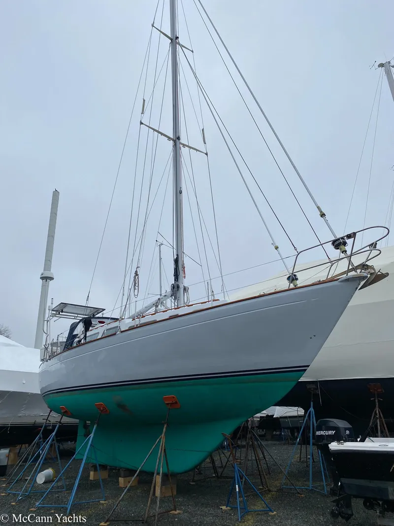 Slide: The Image of 1973 Challenger 40 sailboat on stands, showcasing sleek design and turquoise hull. - 5